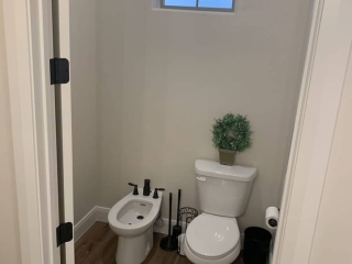 Bidet and Toilet in "throne room" Bathroom featuring toilet and bidet